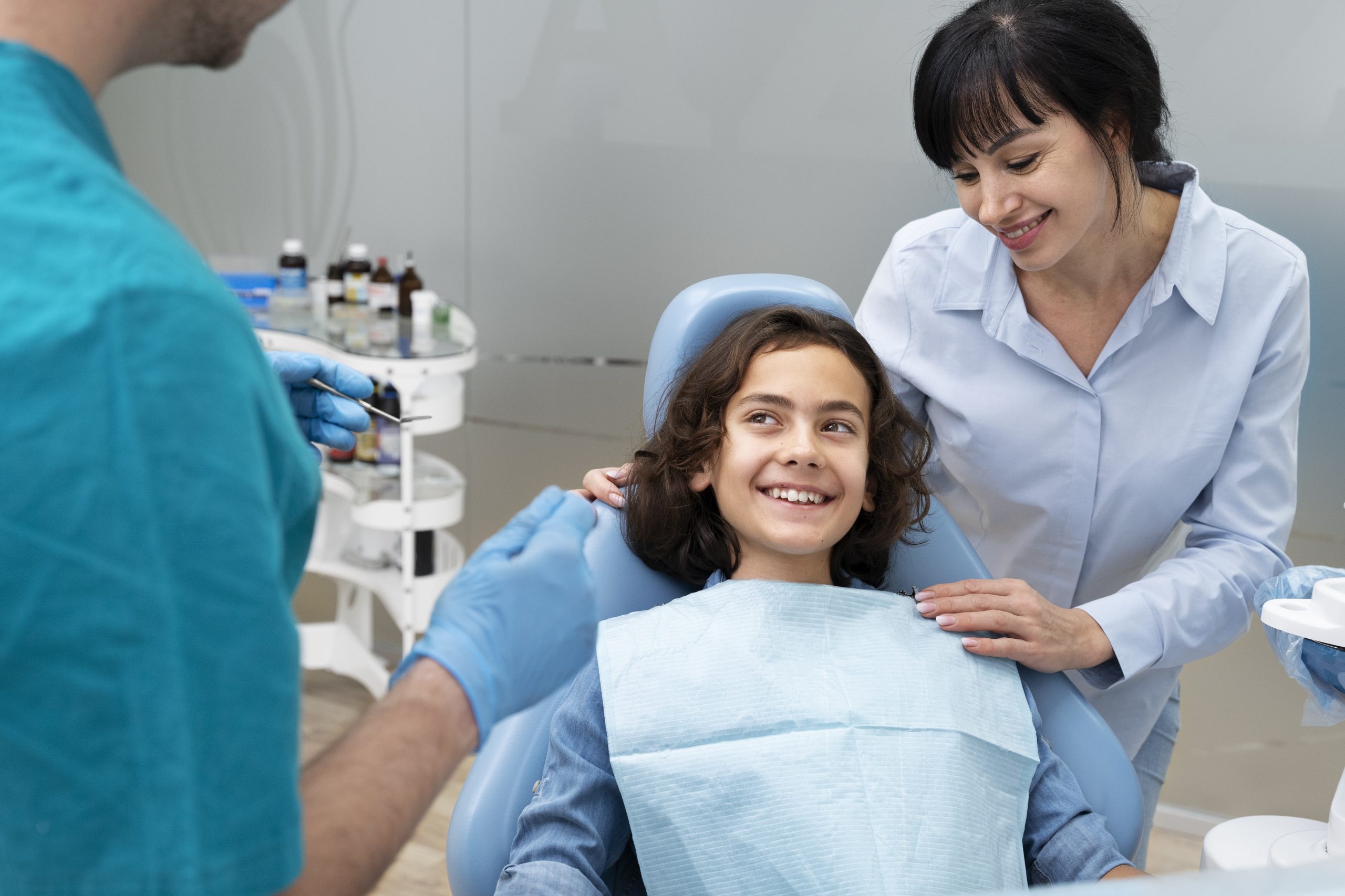 Pediatric dentist gently examining a baby's gums during first dental visit