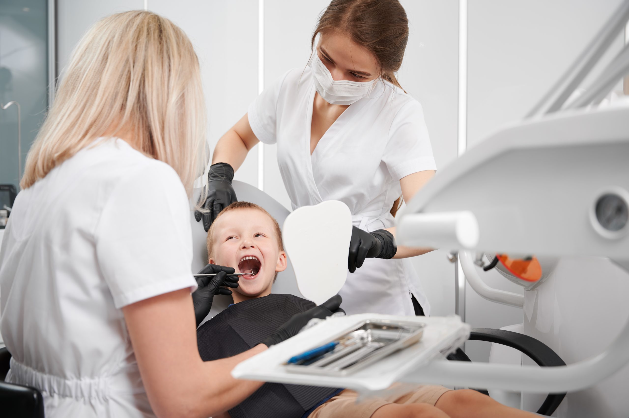Pediatric dentist gently working with a child who has special needs