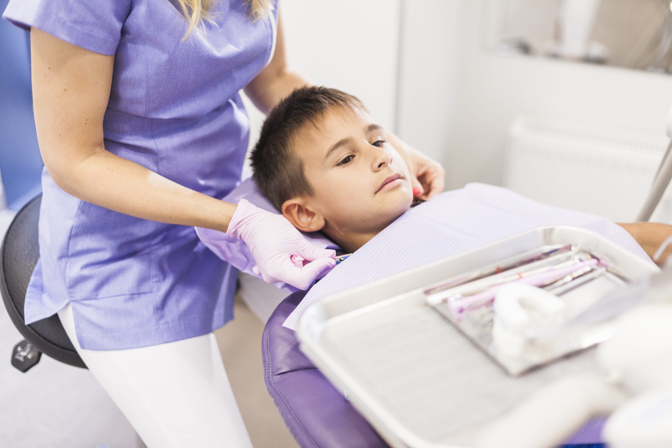 Pediatric dentist examining a child’s teeth during a dental checkup
